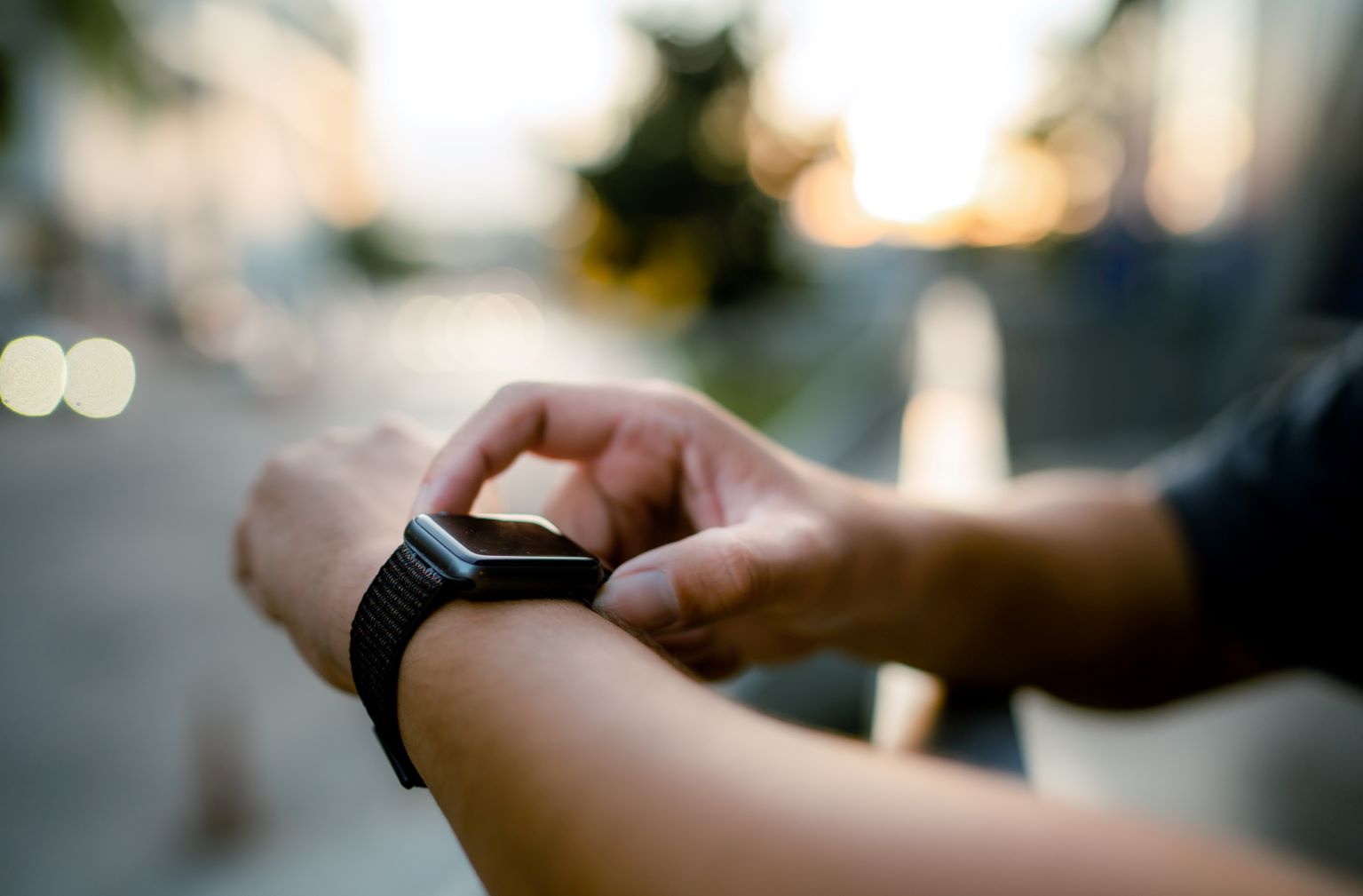 a man adjusting his smartwatch